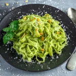 Freshly prepared green spaghetti served with grilled chicken and a light garlic sauce.